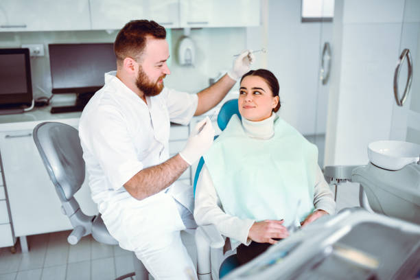 istock Smiling Female Flirting With Dentist During Appointment 1361583927