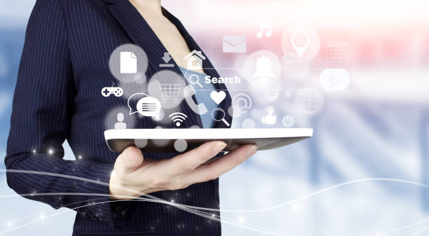 istock Social media concept. Communication network. Hand hold white tablet with digital hologram social media icons sign on light blurred background. Digital online concept. 1361587906