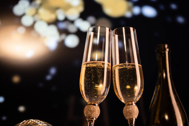 istock happy New Year champagne glasses and fireworks celebration background 1361588009