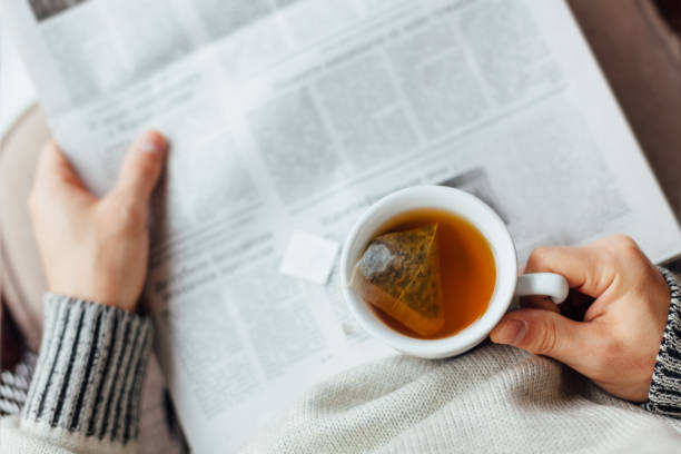 Close up of man reading newspapers.