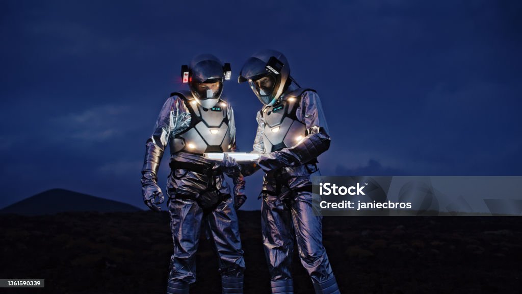 Selfie out of this world. Astronauts in futuristic suits taking photo and setting the light Space travelers having photo session. Having fun and posing for photos Astronaut Stock Photo
