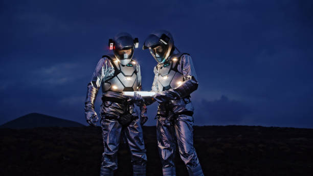 selfie out of this world. astronauts in futuristic suits taking photo and setting the light - space exploration imagens e fotografias de stock