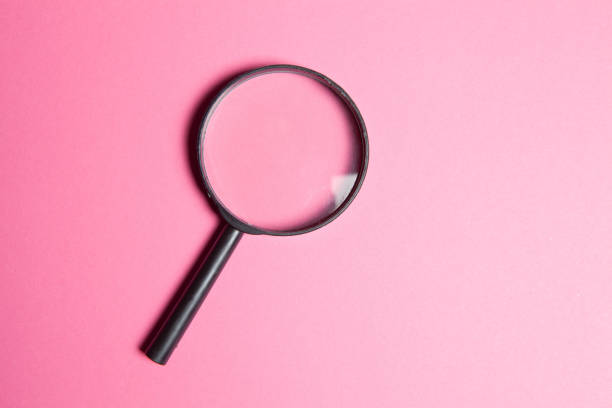 istock black magnifier on pink background 1361590361