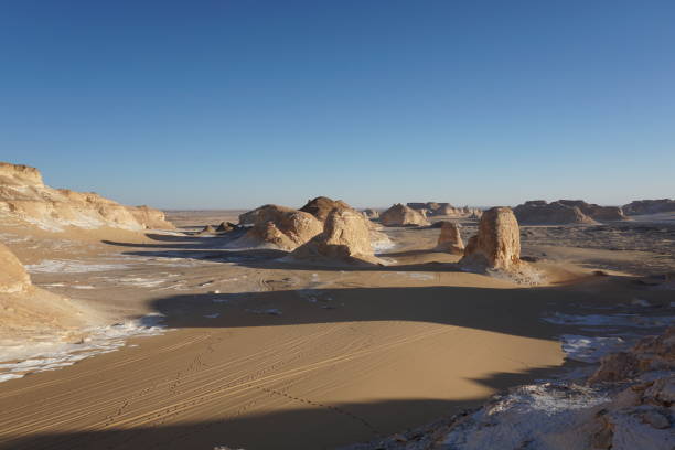 istock Long shadows of rock formations in the white desert 1361590550