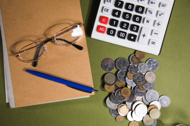 istock coins, calculator, glasses and notepad on the table 1361592159