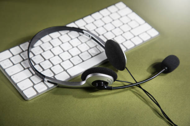 istock headphones on white keyboard 1361592186