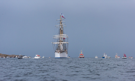 Lindesnes, Norway - August 07 2021: Sail training vessel Statsraad Lehmkuhl greeted by an armada of small boats.