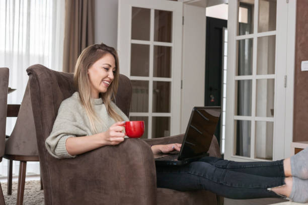 istock Woman using laptop at home 1361596370