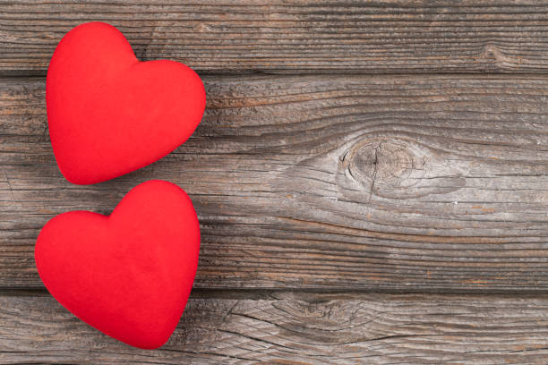 istock Hearts on wooden background 1361597223
