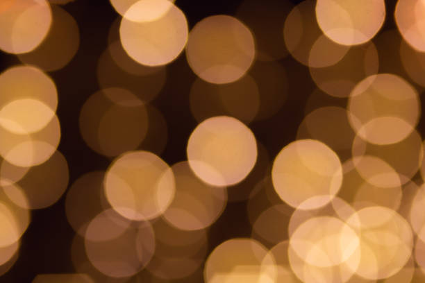 istock Blurred background with bokeh lights in golden tones 1361597321