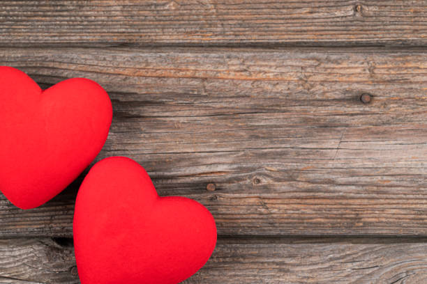 istock Hearts on wooden background 1361597358