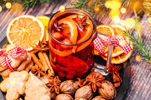 istock On a black ceramic plate is a cup with mulled wine in it, cinnamon sticks with star anise and dried oranges and nuts with Christmas cookies,on a dark wooden background.Seasonal Christmas mulled drink.Christmas table hot alcoholic drink . 1361598136
