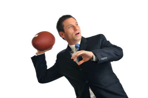 Businessman Throwing American Football Isolated on White Background
