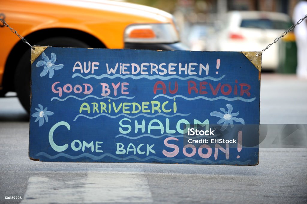 Goodbye Written in Several Languages on Sign Goodbye Written in Several Languages on Signhttp://www.erichoodphoto.com/istock/travel.jpg Blue Stock Photo