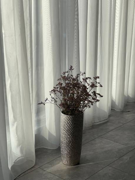 istock vase with flowers on floor 1361599768