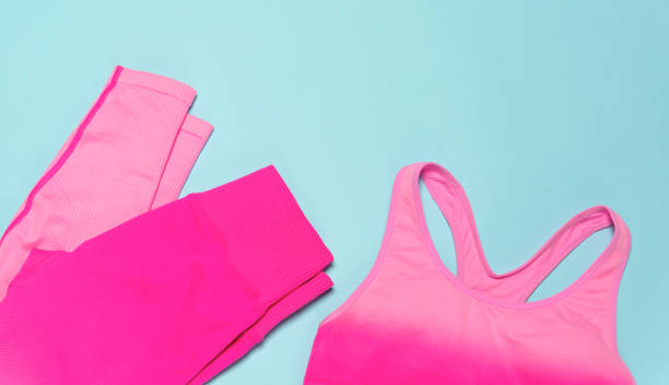 istock Women's tracksuit pink leggings and bras on a blue background. 1361604251