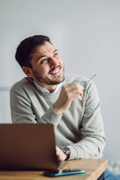 istock Smiling Businessman Working at Home 1361604380