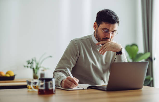 istock Serious Businessman Working at Home 1361604385