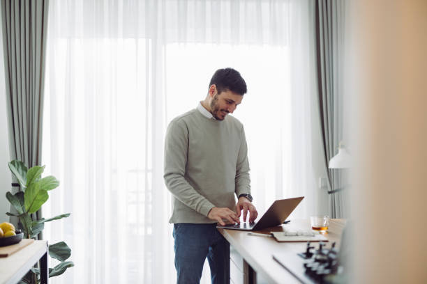 istock Smiling Businessman Working at Home 1361604435