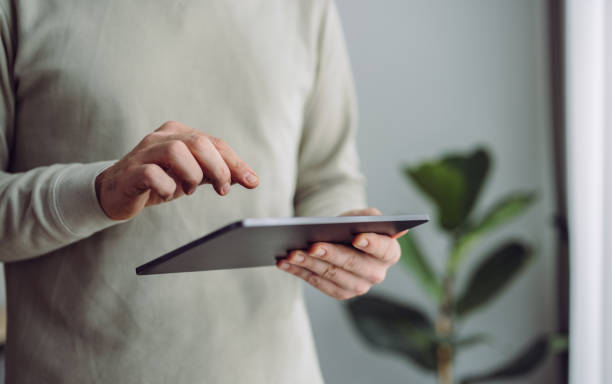An Anonymous Businessman Using Digital Tablet at Home