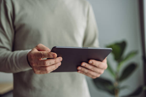 istock An Anonymous Businessman Using Digital Tablet at Home 1361604454