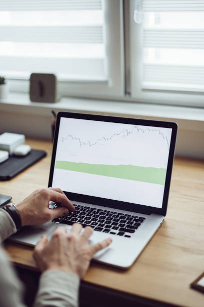 istock An Anonymous Businessman Analyzing Graph on Laptop at Home 1361604455