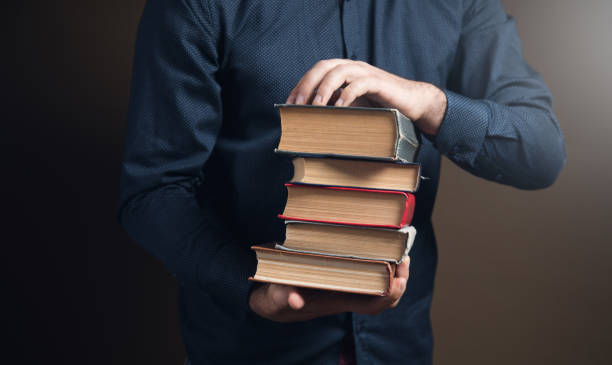 istock man holding books in his hands 1361605858