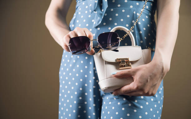 istock young woman posing with bag and glasses 1361605950