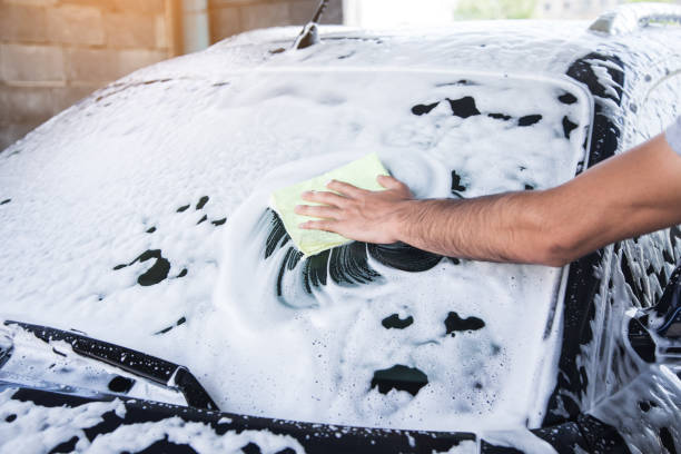 istock a man with a rag wipes the foam on the car 1361606028