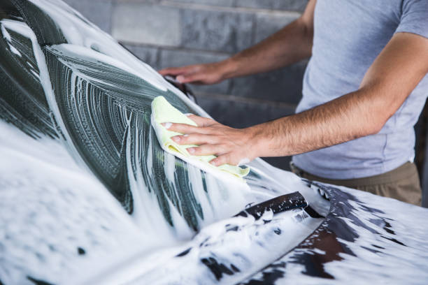 istock a man with a rag wipes the foam on the car 1361606032
