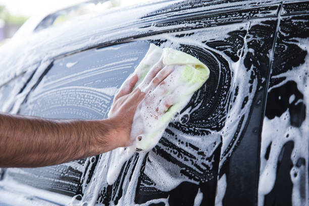 istock a man with a rag wipes the foam on the car 1361606038