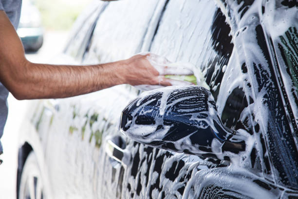 istock a man with a rag wipes the foam on the car 1361606039
