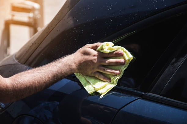 istock wipes a wet car with a rag 1361606629