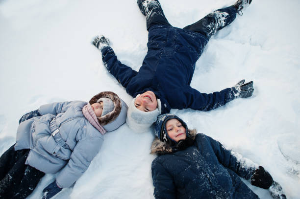 istock Three children in winter nature. Outdoors in snow. 1361606983