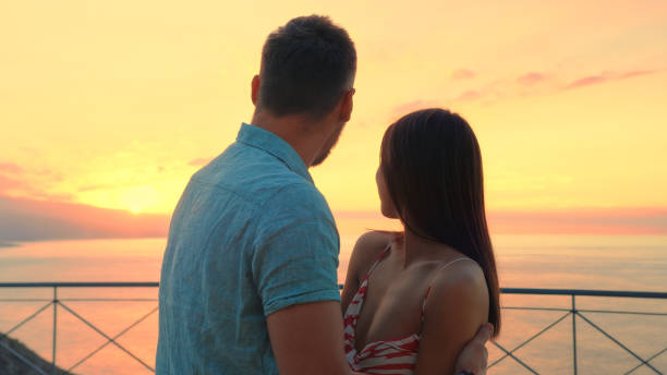 istock Romantic sunset on a patio. Hugging and enjoying the view 1361608095