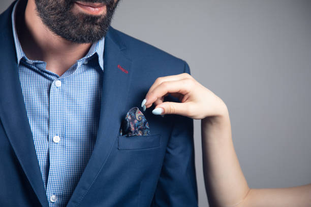 istock a woman straightens a man's suit 1361609107