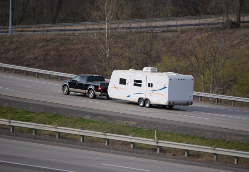 Camper Being Towed by Pickup Truck on the Highway