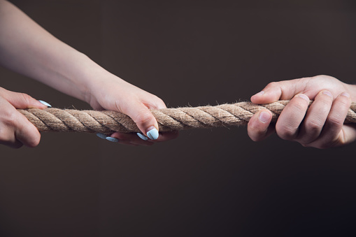 a man and a woman pulling the rope