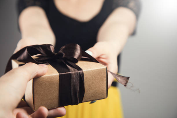 istock a man gives a woman a gift 1361609852