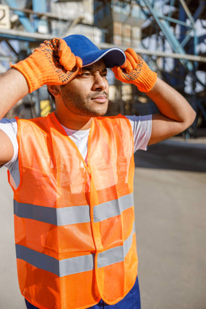 istock Serious construction worker observing construction site of plant 1361611069