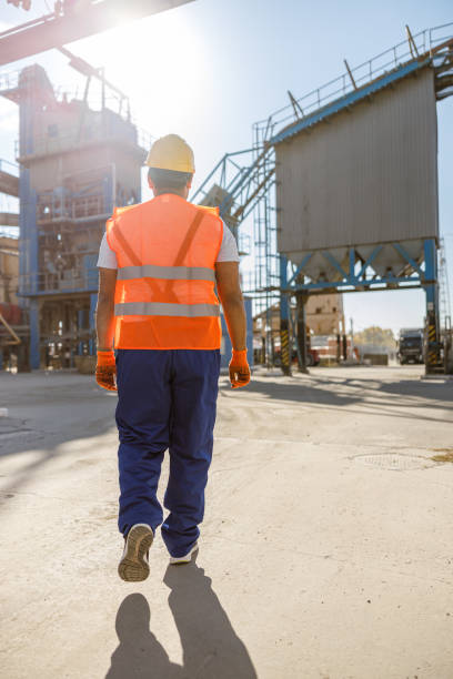 istock Young worker dressed in safety equipment inside factory 1361611092