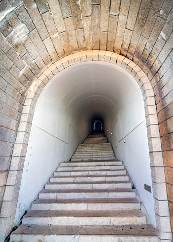 Lovcen National park. Dimly lit steep,white stone steps leading through a long narrow tunnel in the mountain up to the Mausoleum of Petar II Petrovic-Njegos,at the summit.