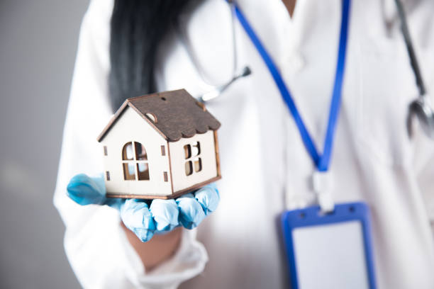 istock the nurse holds the house in her hands 1361614318