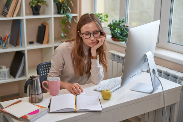 istock Young female student working at computer at home 1361614516