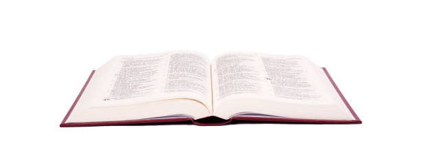 istock Opened  Bible with red cover color isolated on white background. 1361615130