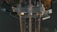 istock Aerial birds eye overhead top down panning view of vehicles driving on Brooklyn bridge over river. Heavy traffic on road. Manhattan, New York City, USA 1361615211
