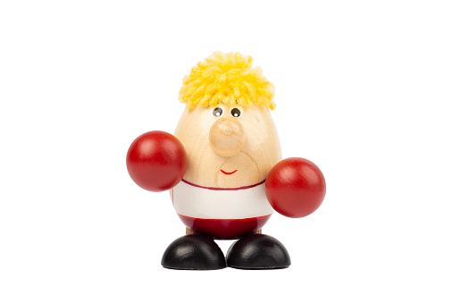 Egg-shaped wooden doll with red boxer gloves.