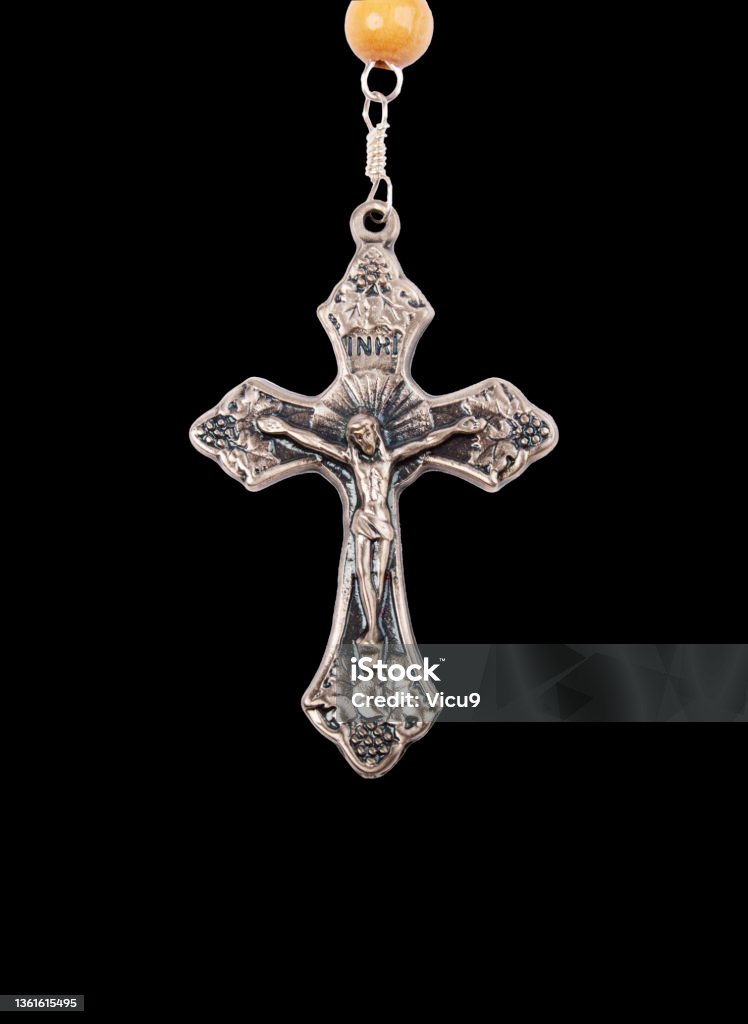 Silver crucifix isolated on black background. Silver crucifix isolated on black background Rosary Beads Stock Photo