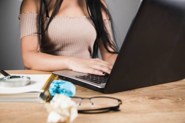 istock woman sitting in front of work table working laptop 1361615500