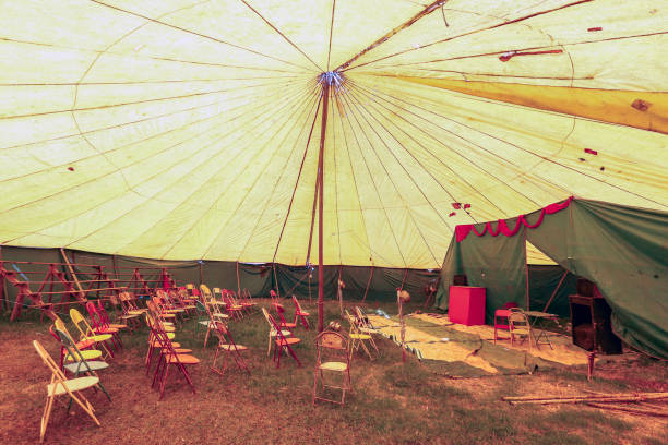 istock Audience of traveling circus with empty chairs 1361616126